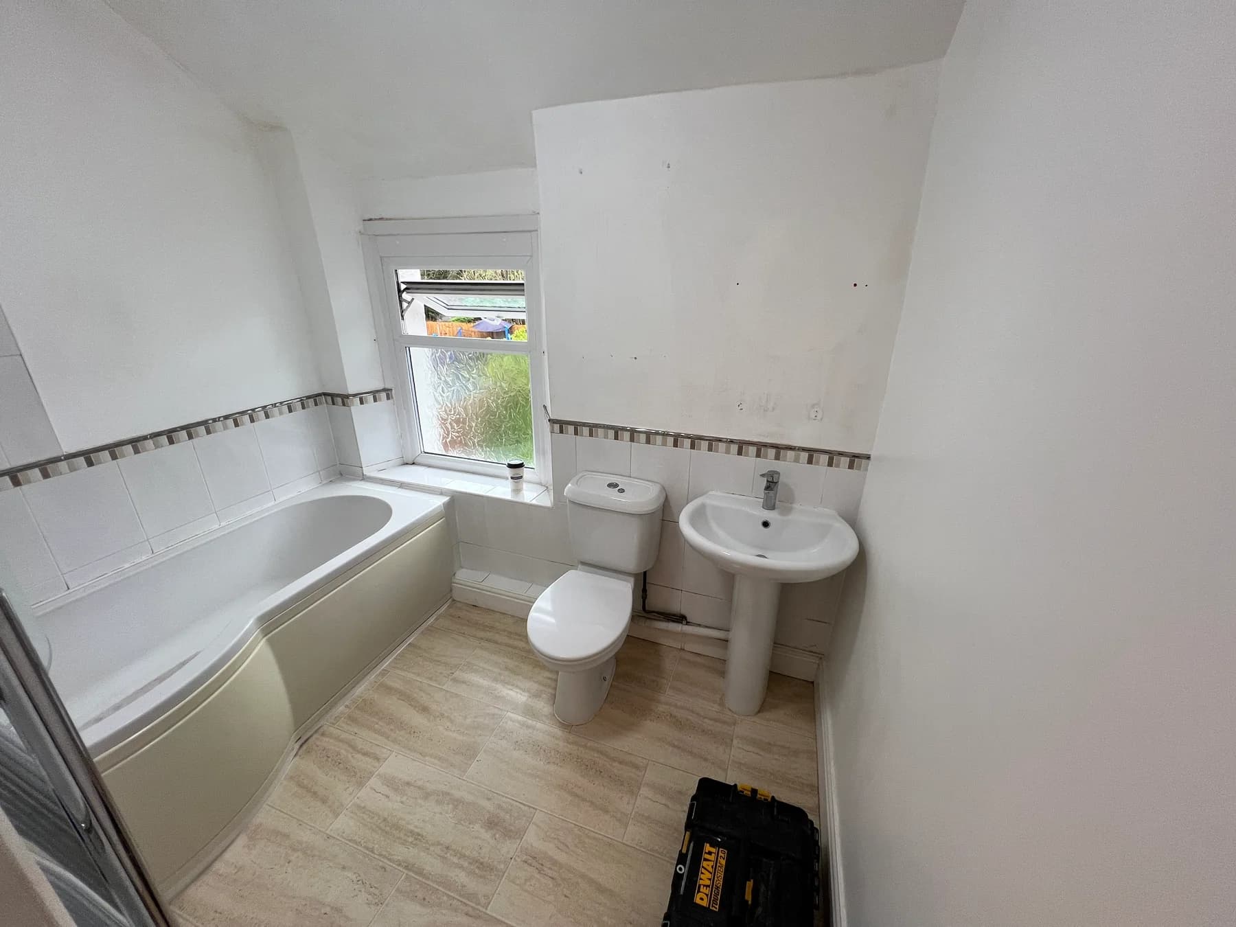 A bathroom stripped back during a Truscon bathroom installation, showing the bath and wall surfaces before new finishes