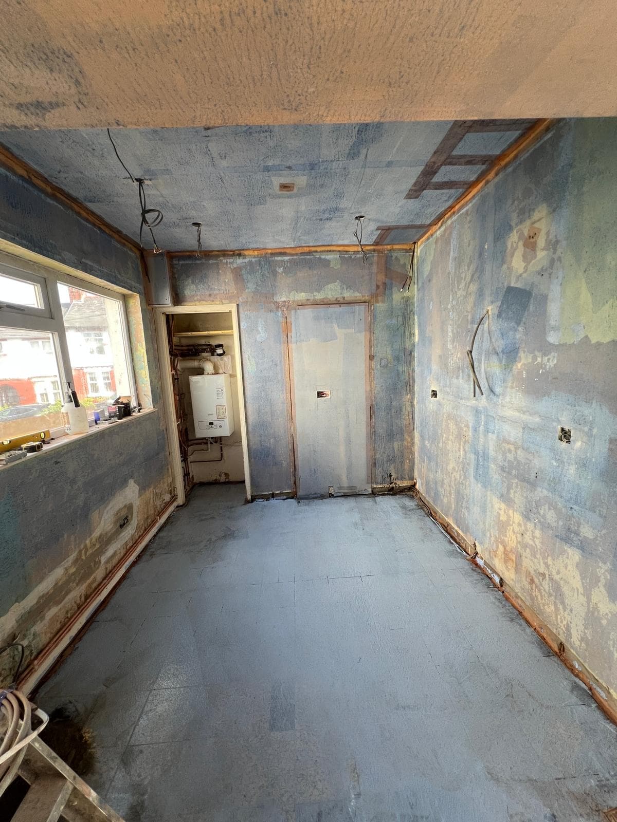 The room stripped back to bare walls and floor before the kitchen refit by Truscon