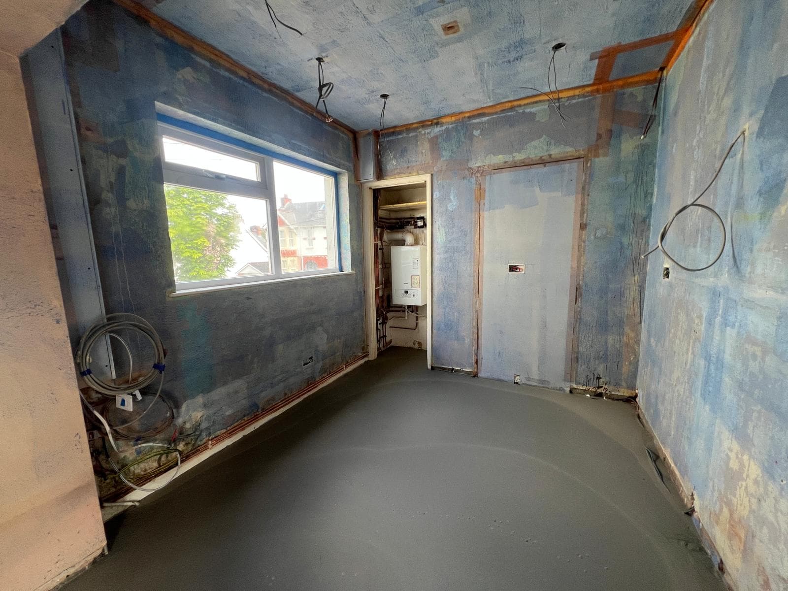 The room stripped back to bare walls and floor before the kitchen refit by Truscon