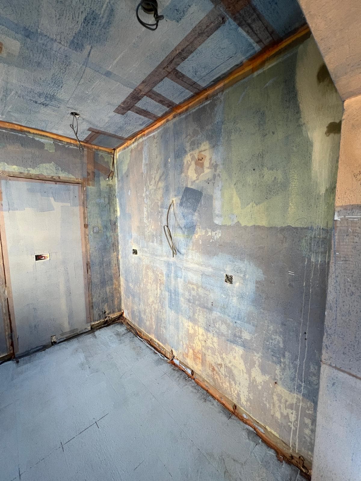 The room stripped back to bare walls and floor before the kitchen refit by Truscon