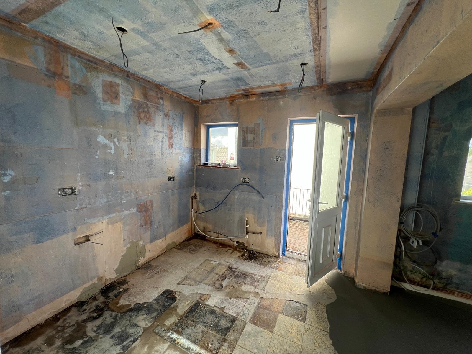 The room stripped back to bare walls and floor before the kitchen refit by Truscon