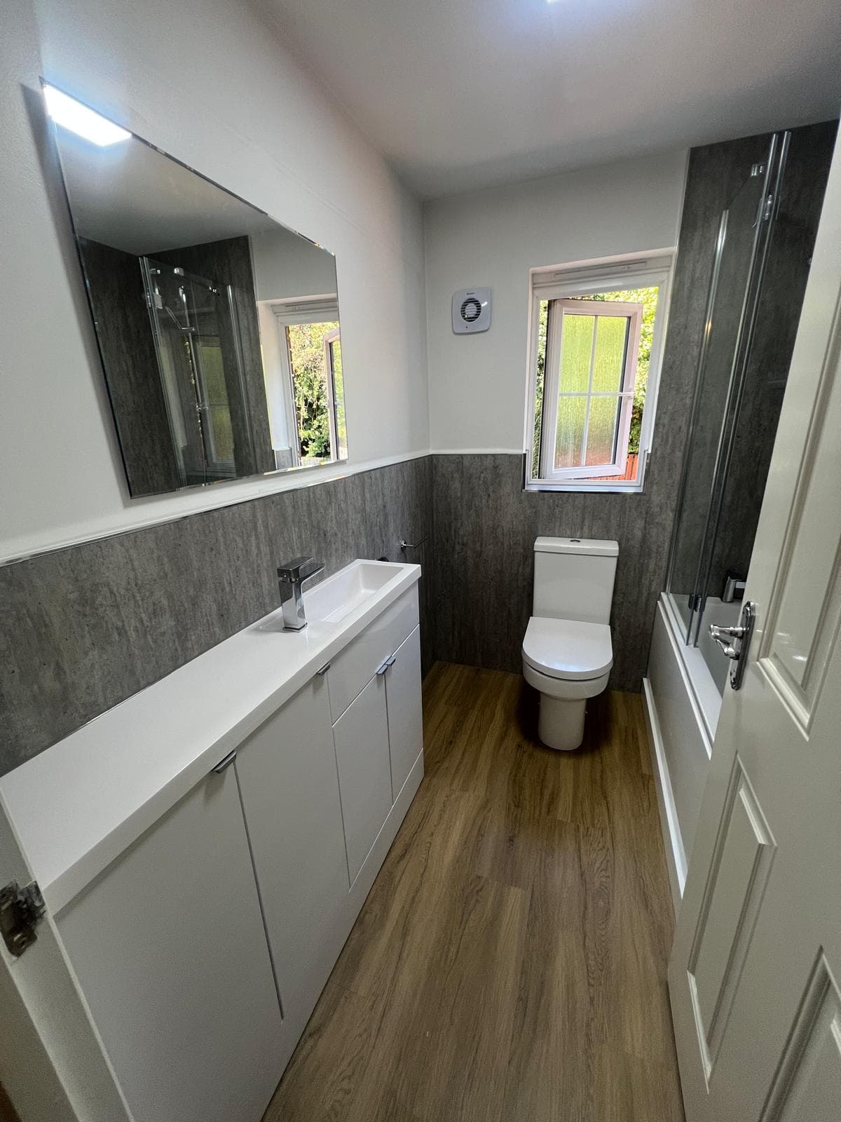 Bathroom vanity unit, toilet and grey wall panelling, fitted by Truscon