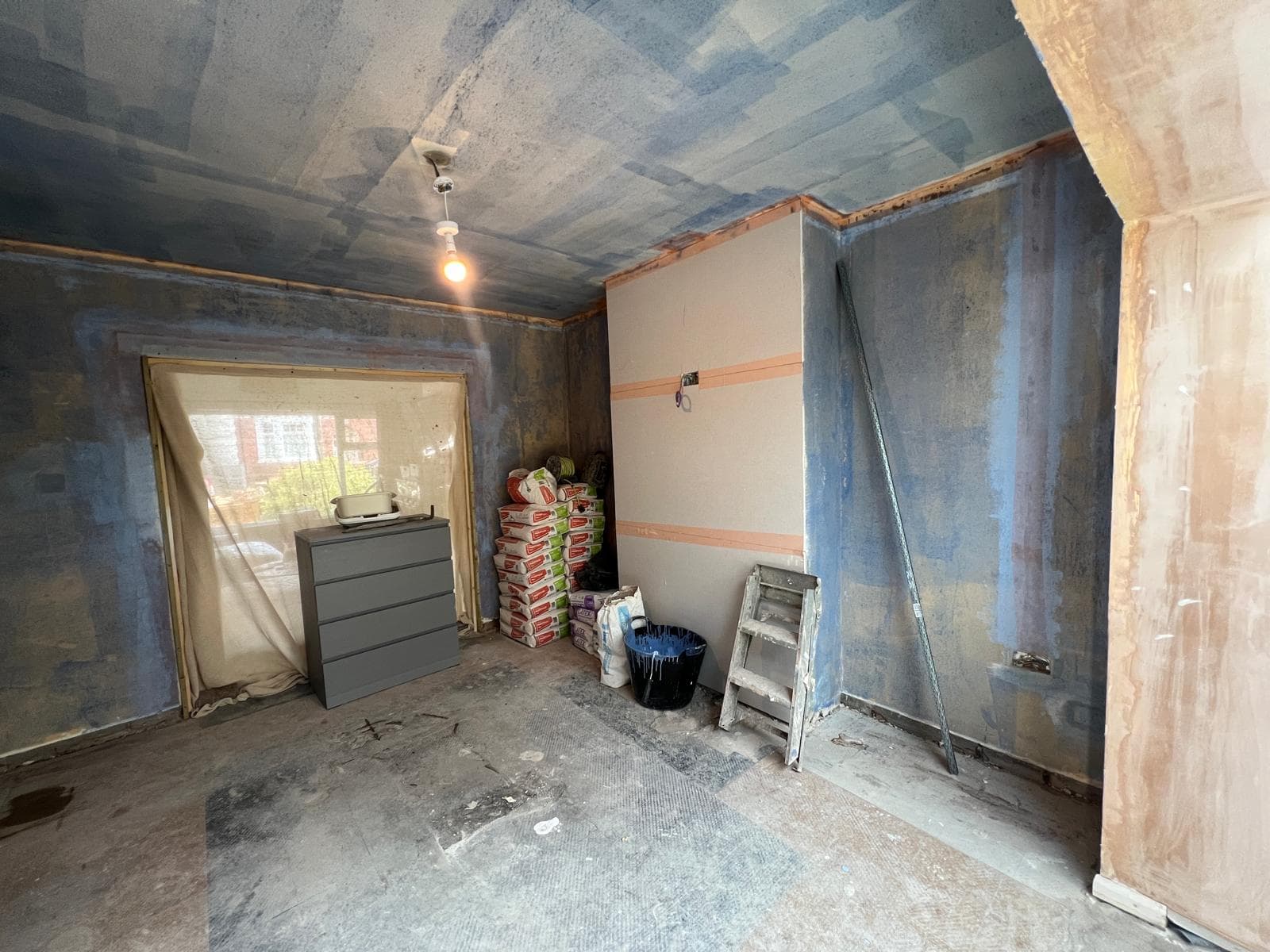 The room stripped back to bare walls and floor before the kitchen refit by Truscon