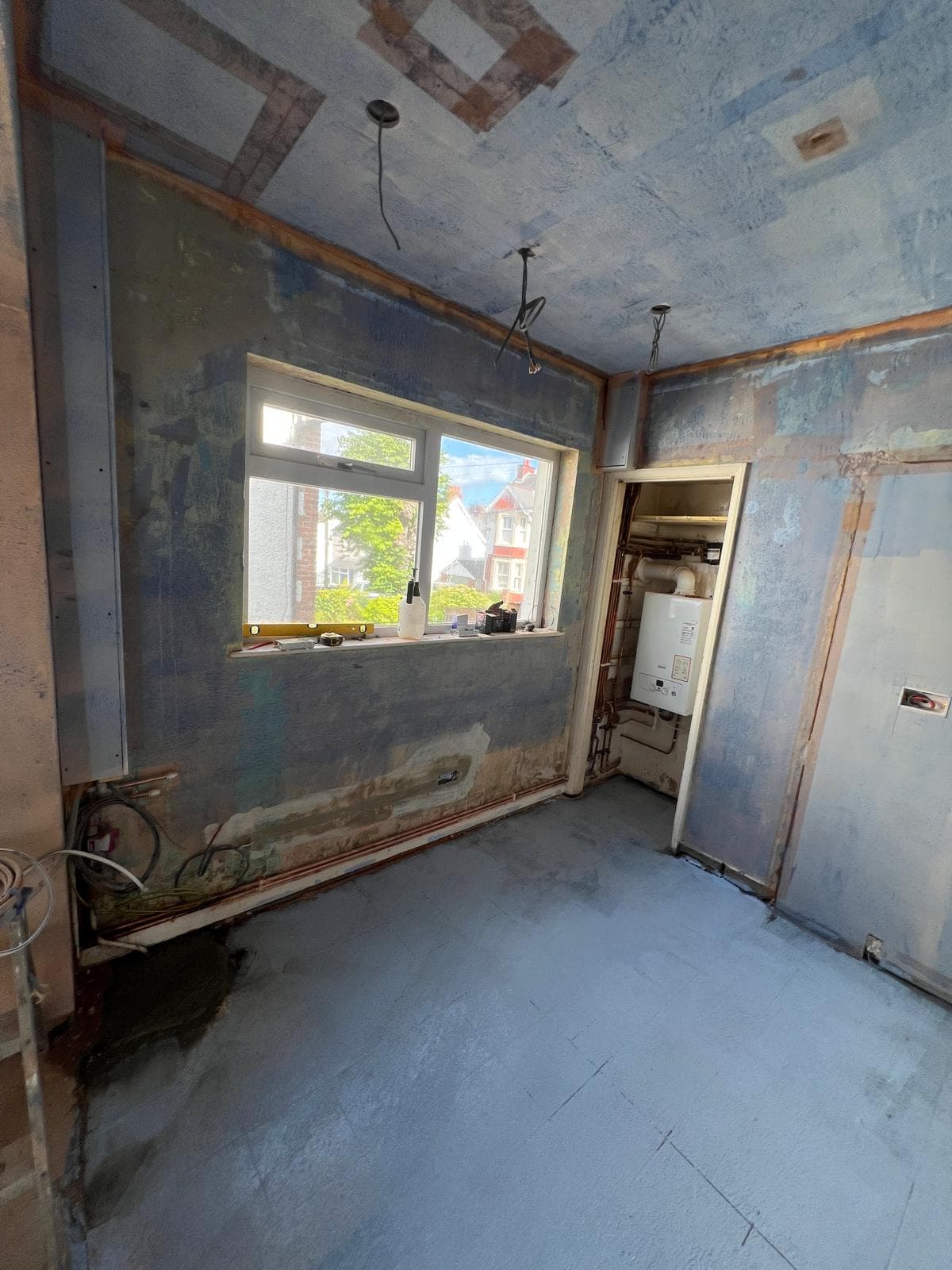 The room stripped back to bare walls and floor before the kitchen refit by Truscon