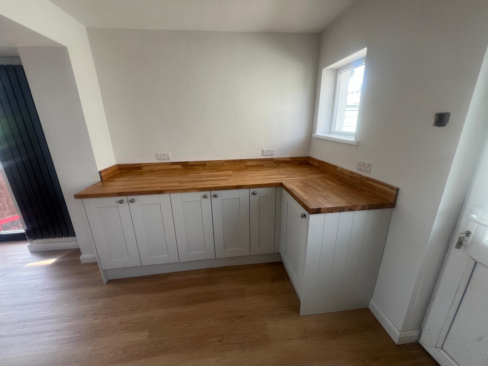 L-shaped utility run with oak worktops, fitted by Truscon