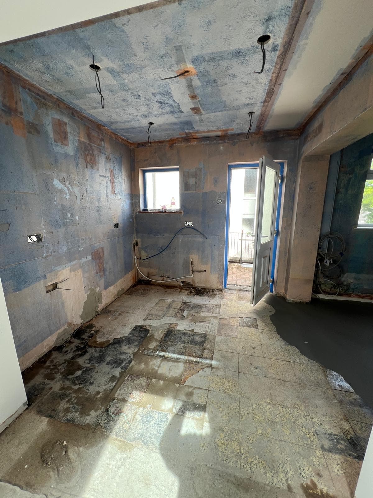 The room stripped back to bare walls and floor before the kitchen refit by Truscon