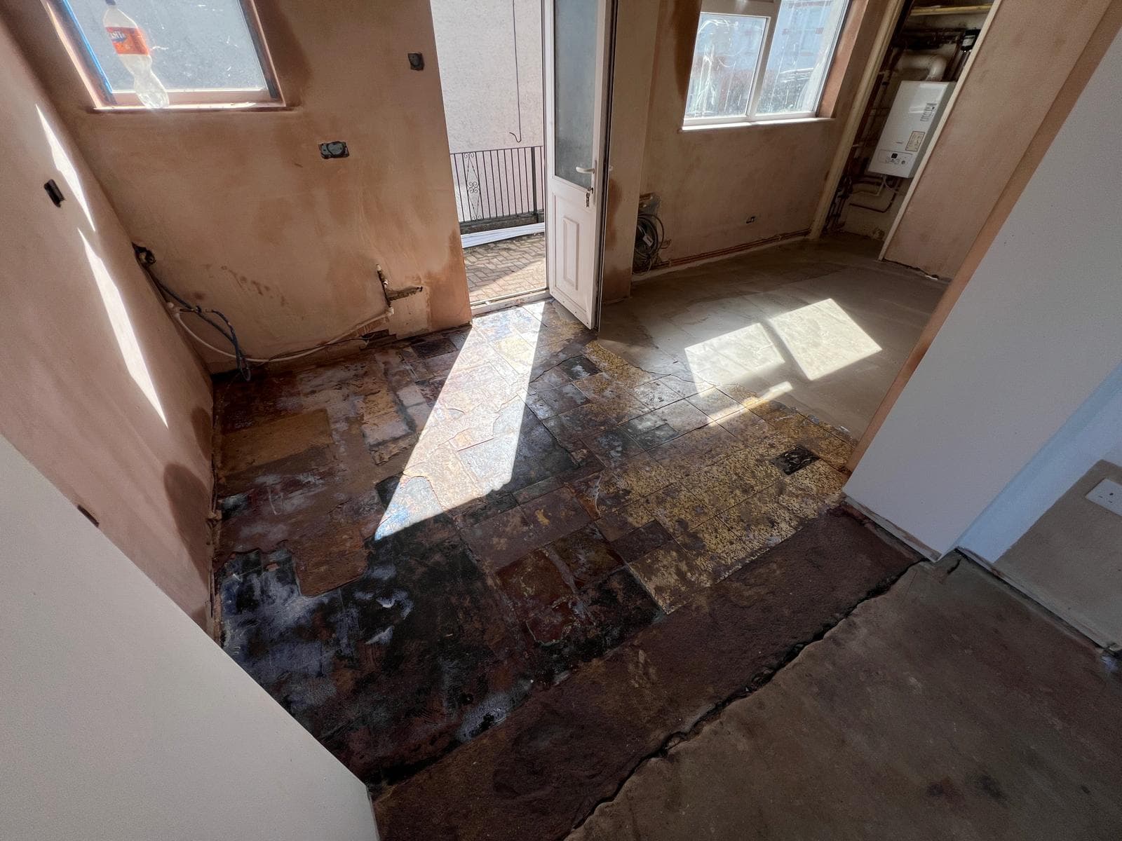 The room stripped back to bare walls and floor before the kitchen refit by Truscon
