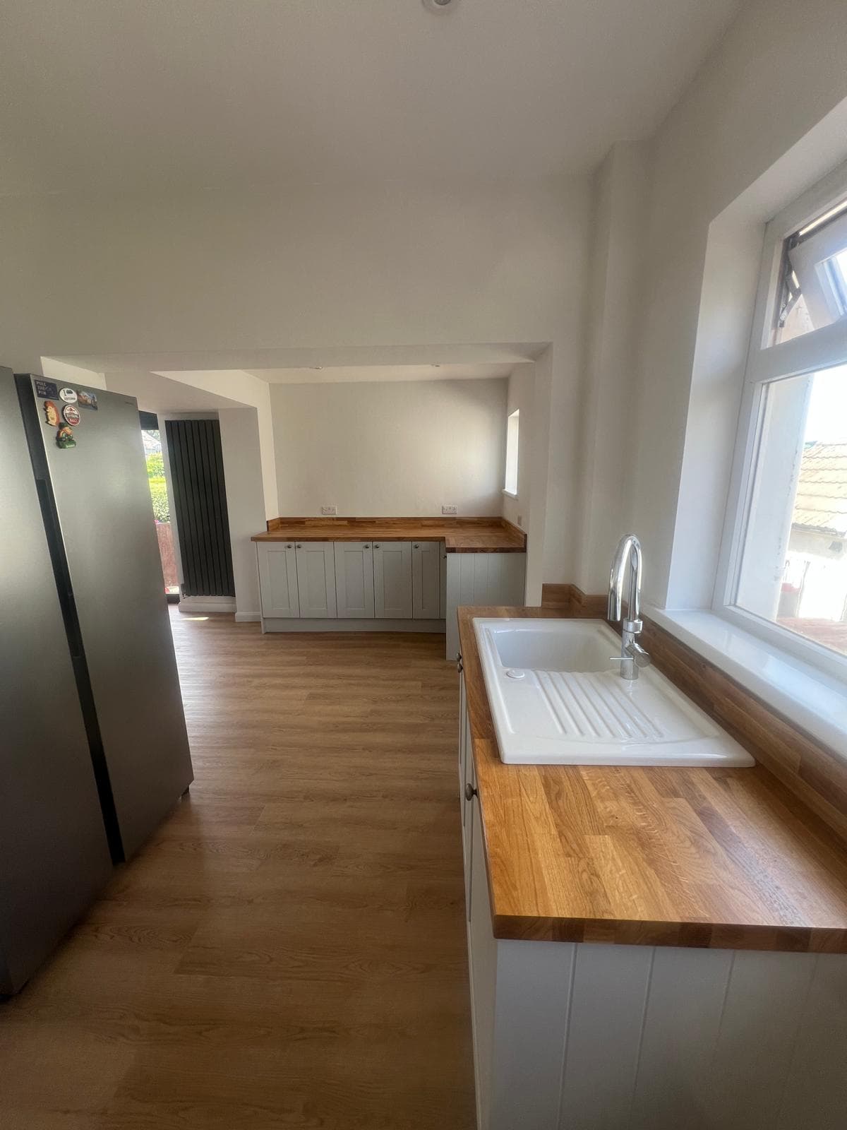 Ceramic sink and oak worktops in a kitchen refitted by Truscon